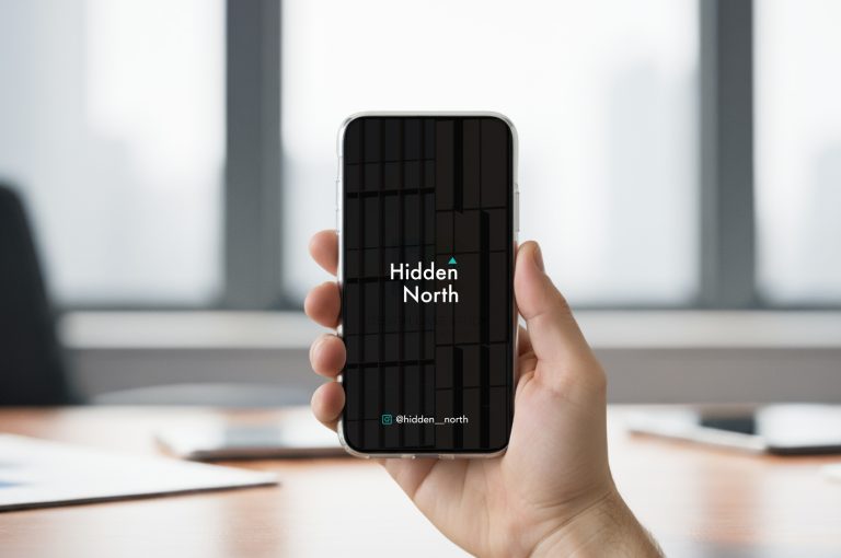 Person holding phone showing Hidden North branding mockup, minimal interior background, Fitzroy-inspired photography branding design
