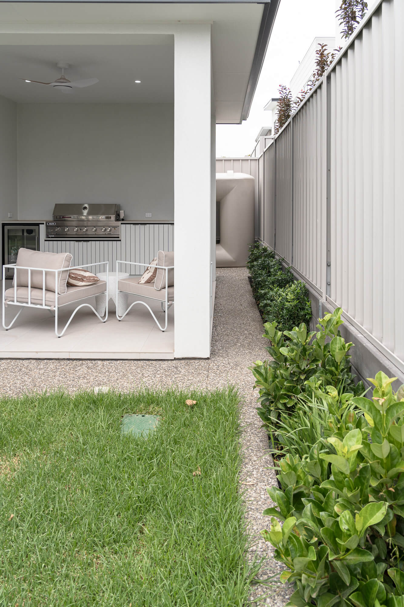 Covered patio framing a landscaped garden with lawn and planting
