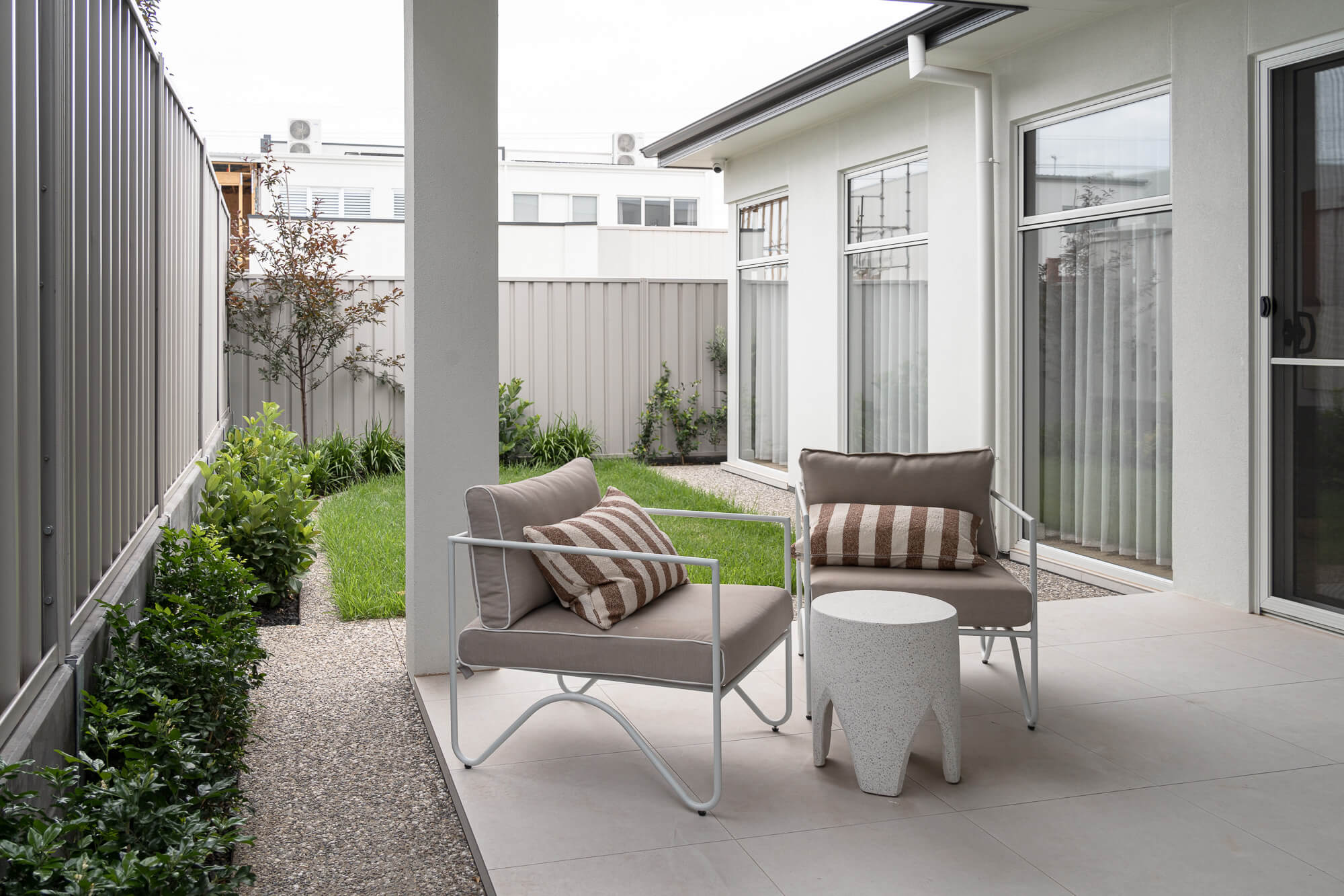 Residential landscape garden design with modern seating area and lawn in Melbourne
